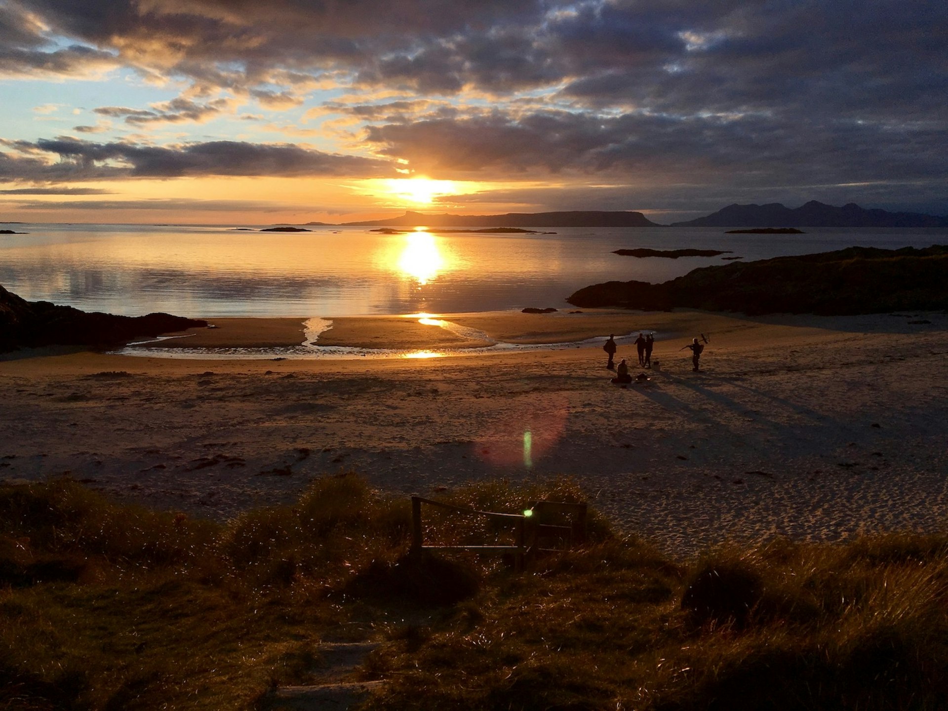 People on watch the sunset from Camusdarach Beach, Morar, Scotland, United Kingdom