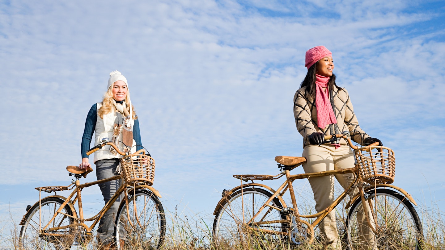 Women cycling on the dunes near Chatham in Cape Cod