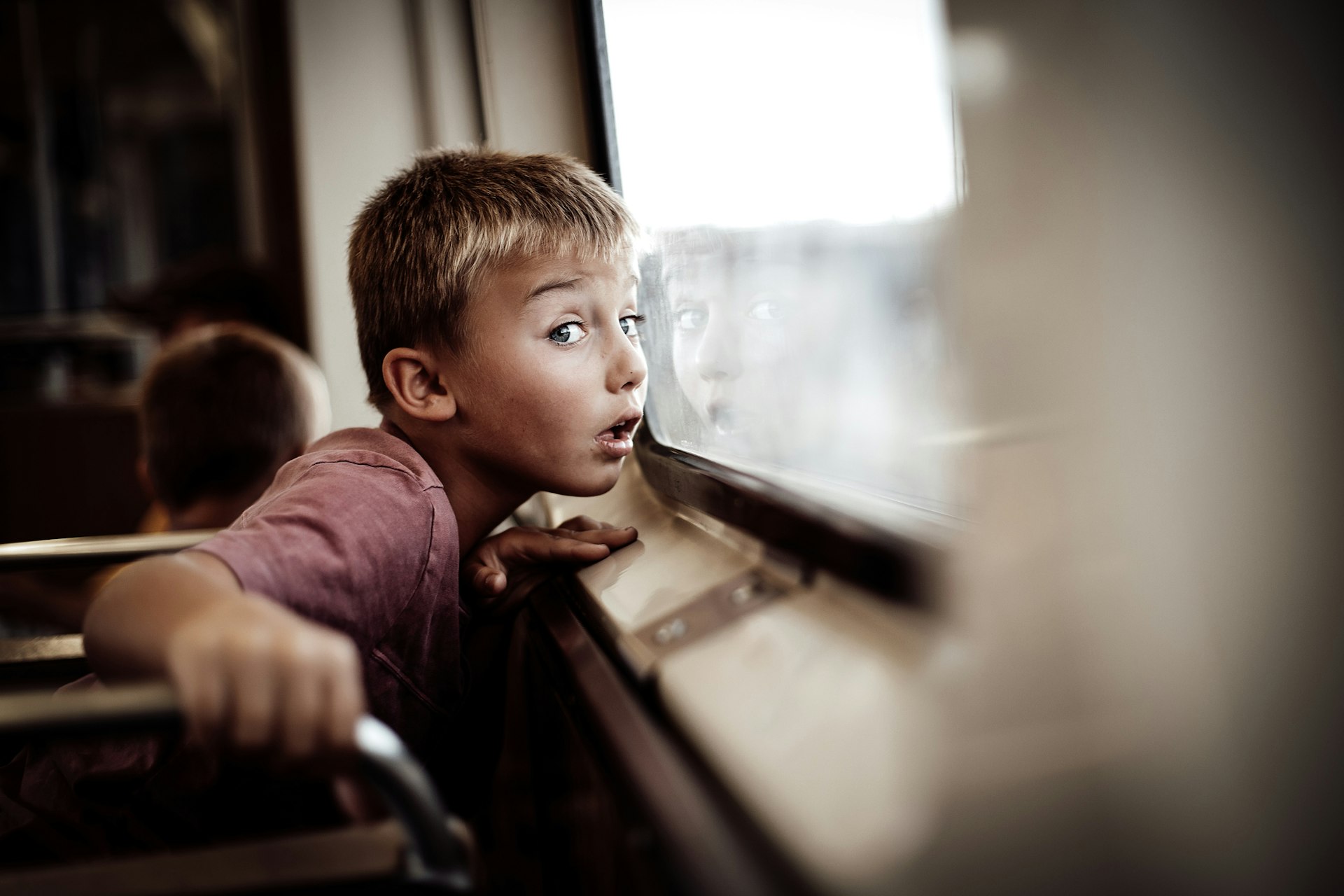 A boy looks out the window on an elevated train (“L”) in Chicago, Illinois, Midwest, USA