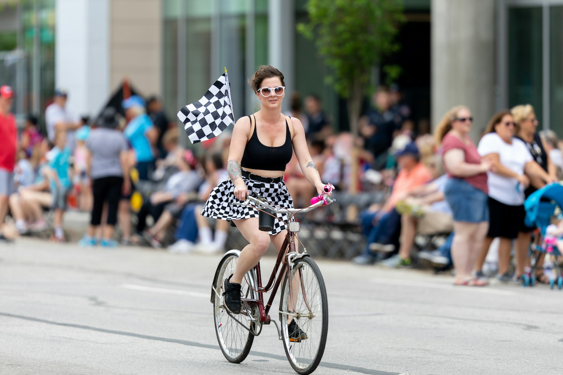 A woman rides a bike down Pennsylvania Street prior to the Indy 500 Parade, Indianapolis, Indiana, Midwest, USA