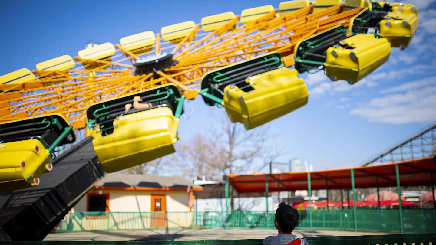 A child watches the rides at Carowinds theme park on the border between North and South Carolina