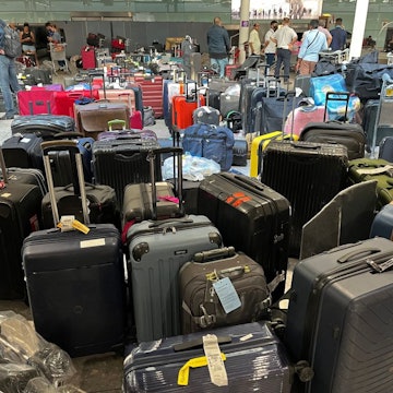 Suitcases are seen uncollected at Heathrow's Terminal Three bagage reclaim, west of London on July 8, 2022. - British Airways on Wednesday axed another 10,300 short-haul flights up to the end of October, with the aviation sector battling staff shortages and booming demand as the pandemic recedes. (Photo by Paul ELLIS / AFP) (Photo by PAUL ELLIS/AFP via Getty Images)