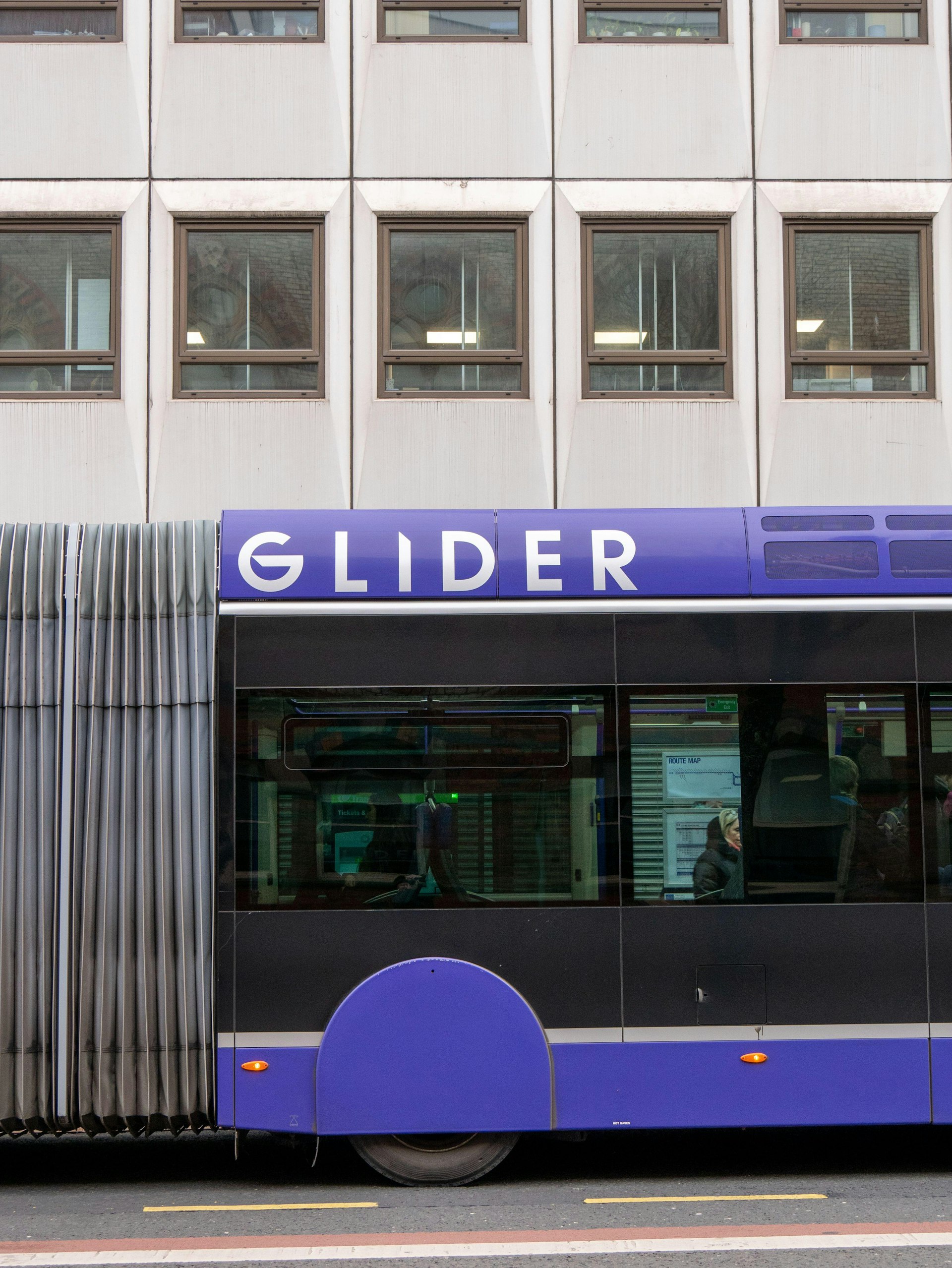 The side of a "bendy bus" service in Belfast with the word "Glider" written on it