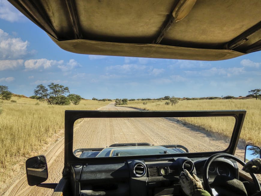 4x4 safari vehicle driving on a dirt road