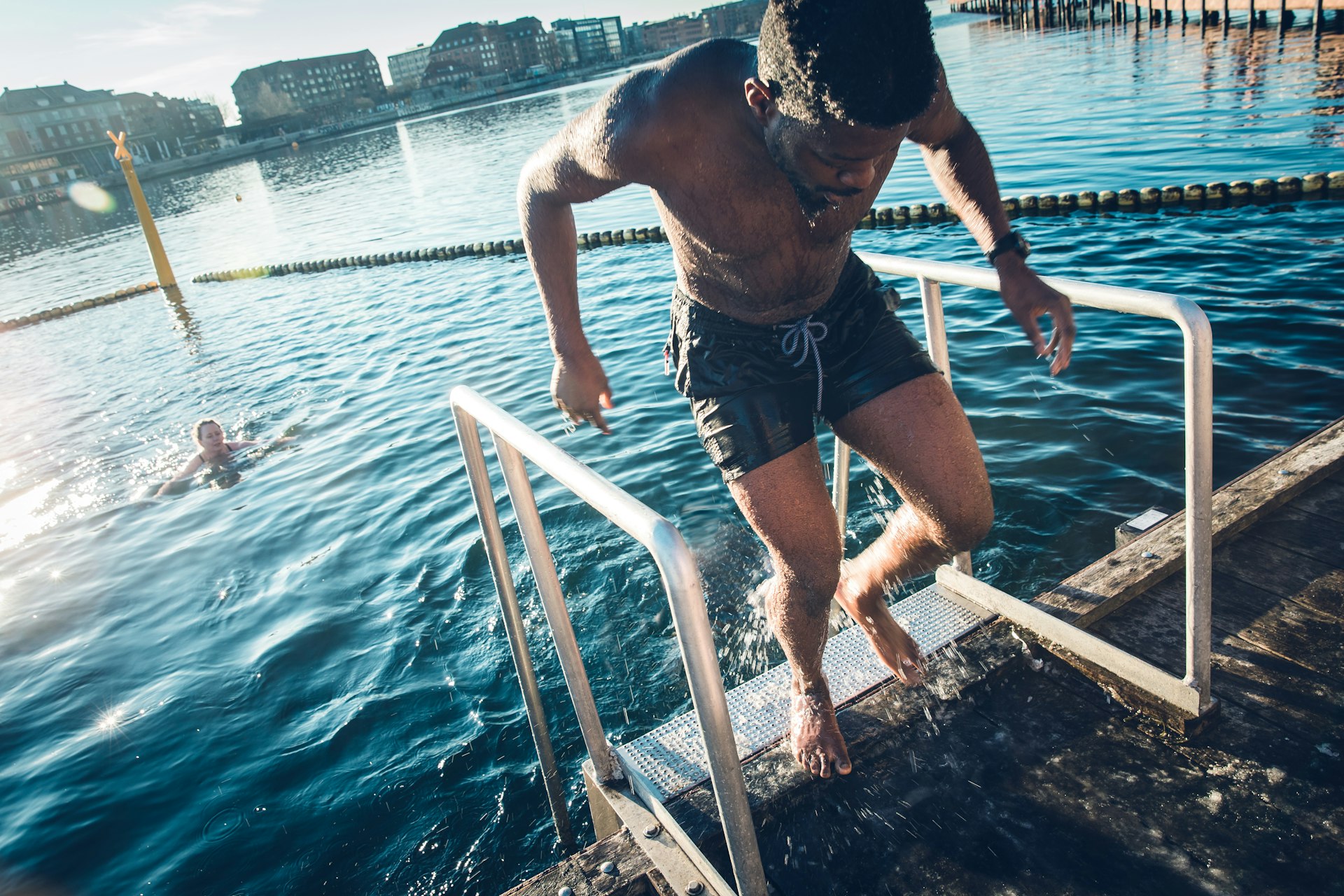 A man comes out of the water after a swim in the harbor of Copenhagen, Denmark, Europe