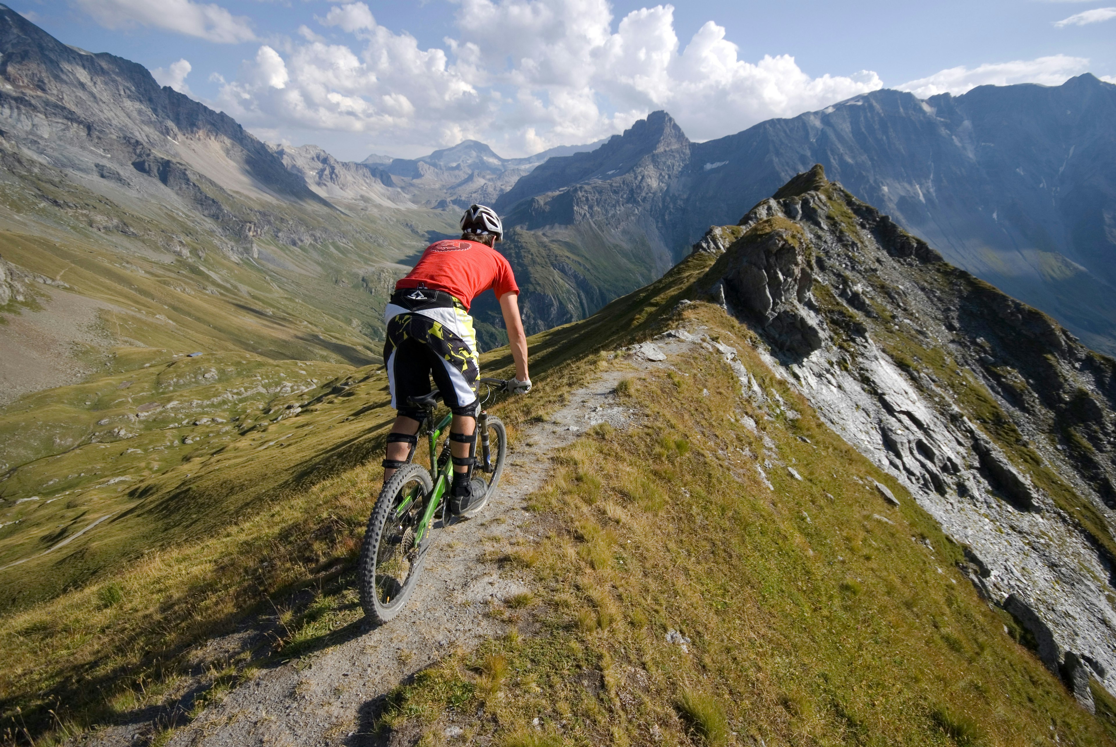 A mountain biker rides a trail on a ridge near Les Arcs in the French Alps