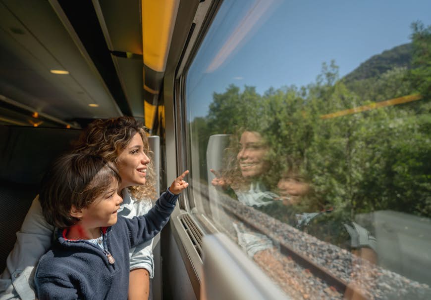 A mother and son riding on a train in France