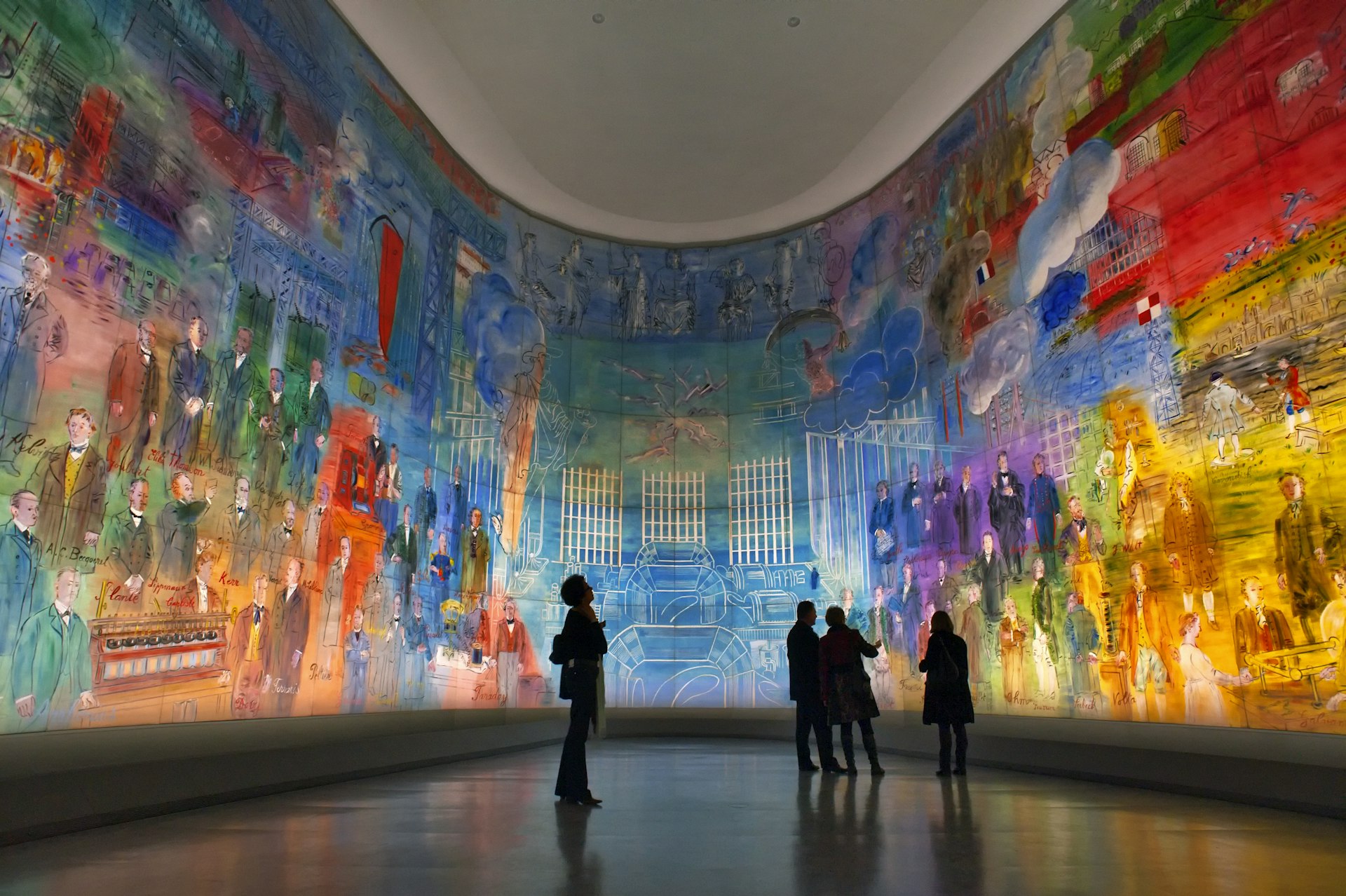 A vast room with walls backlit showing a mural