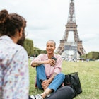 People enjoying relaxing or working near Eiffel tower in Paris, France