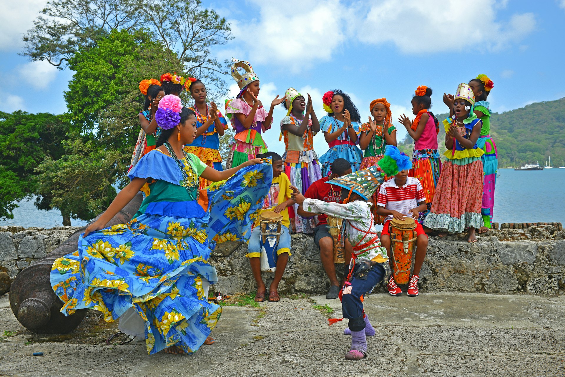 A group of young Panamenians performing the Congo dance in one of the Spanish fortresses (hence the cannons) of Portobelo by the Caribbean Sea, Panama, Central America
