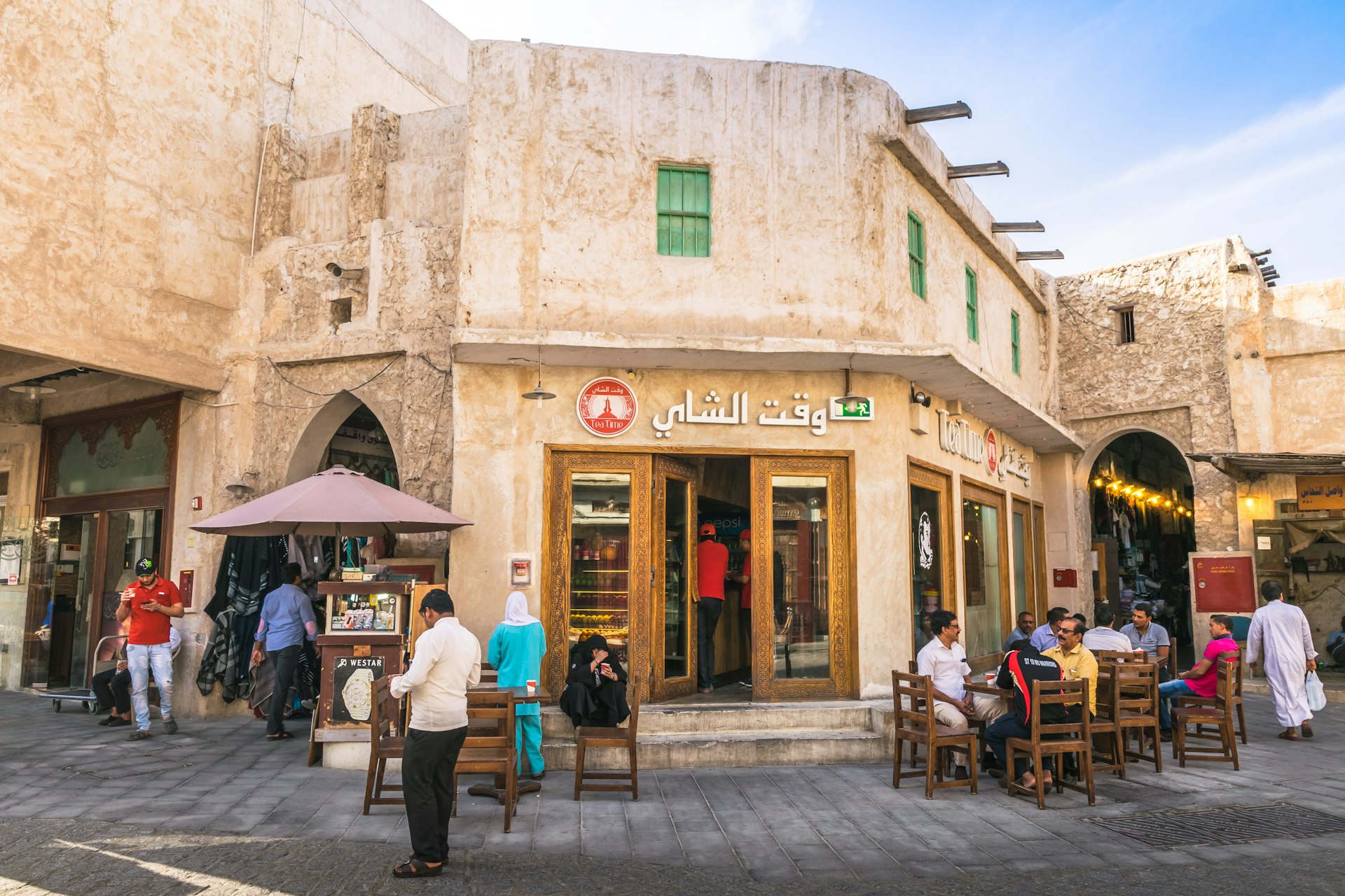 People sitting and relaxing in coffee shop at Souq Waqif street.