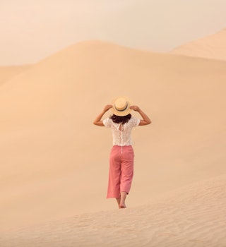 Woman Walking In The Desert, Qatar

