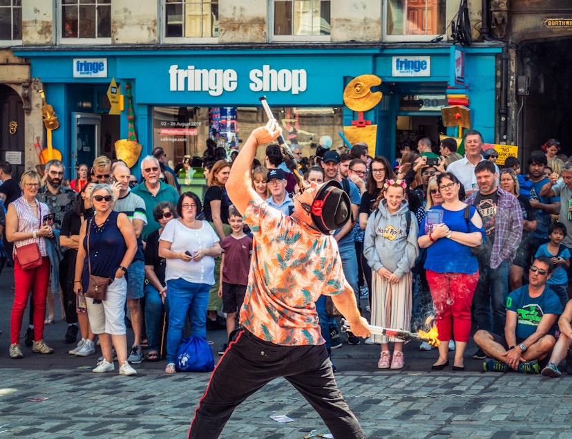 Edinburgh, Scotland - A crowd of spectators watching a street performer on the Royal Mile in Edinburgh's Old Town, during the city's Festival Fringe, held during August.