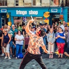 Edinburgh, Scotland - A crowd of spectators watching a street performer on the Royal Mile in Edinburgh's Old Town, during the city's Festival Fringe, held during August.