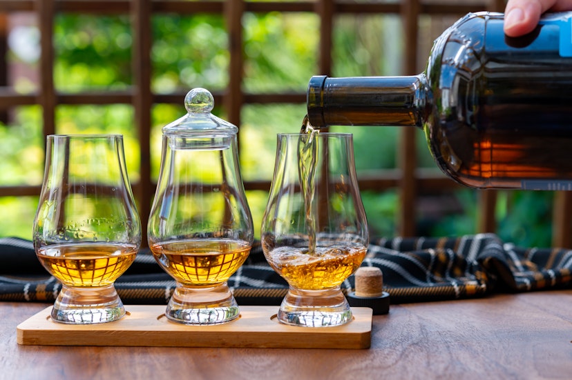 Tasting of different Scotch whisky drinks in traditional old British house with wooden windows