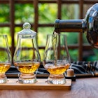 Tasting of different Scotch whisky drinks in traditional old British house with wooden windows