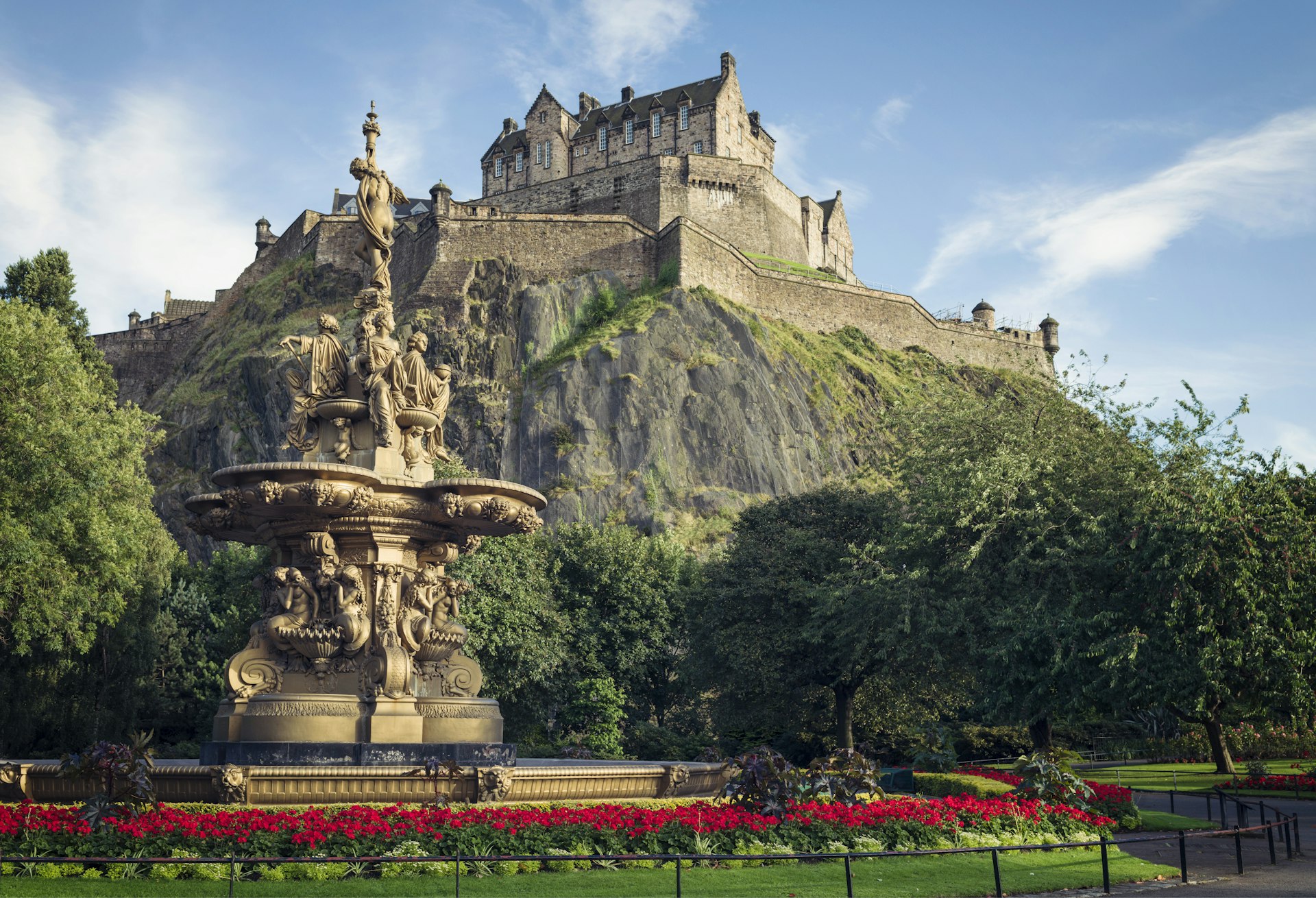 Flowers surrounding the ornate Ross Fountain in Princes Street Gardens in Edinburgh, with Edinburgh Castle in the background