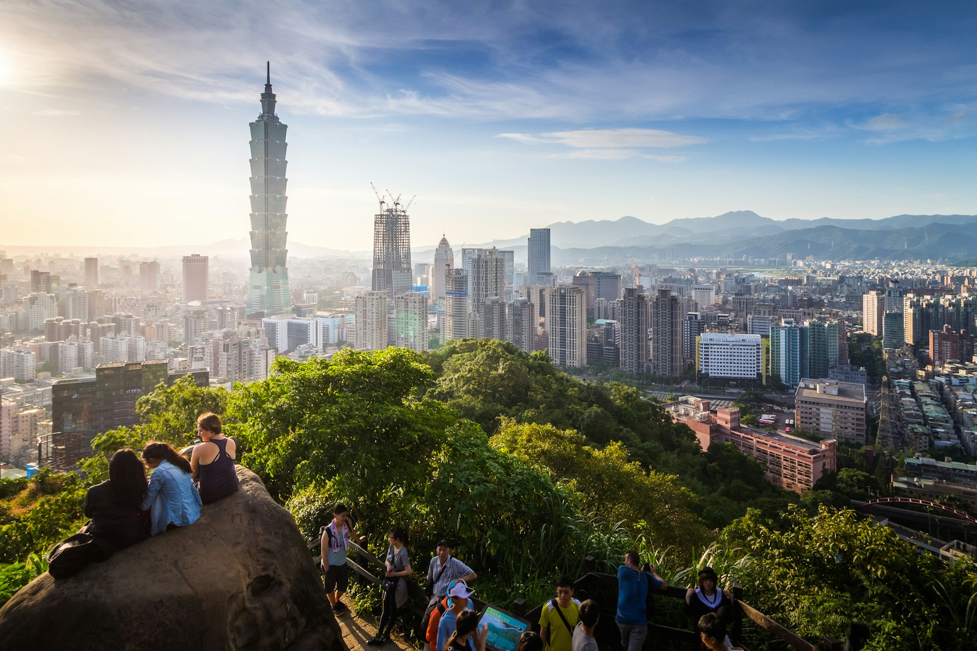 People looking out over view of Taipei City at the top of Elephant Mountain