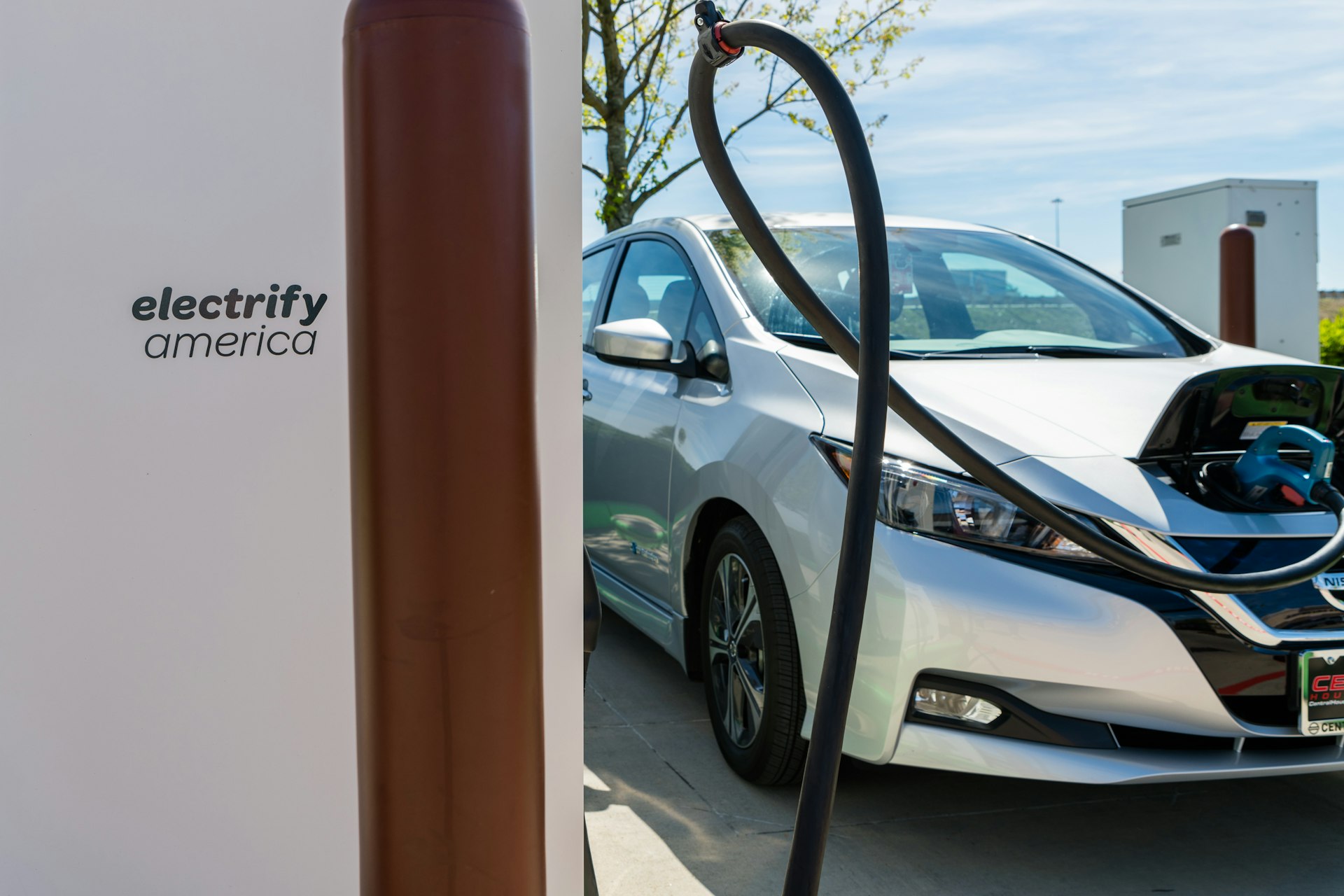 A Nissan Leaf EV charges at an Electrify American charging station