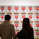 Museum of Modern Art, or MoMA, Manhattan, New York, United States of America - Campbell's Soup Cans, the artwork by Andy Warhol. Leading figure in pop art. Famous work. Visitors watching.