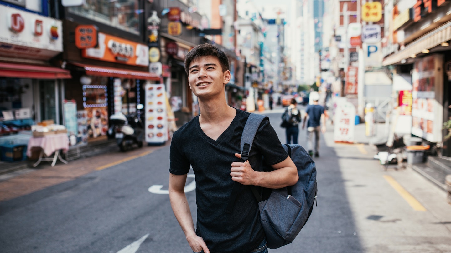 South Korean youth lifestyle in the capital city. Mixed race young millennial man half Korean, half Russian living and studying in Seoul.