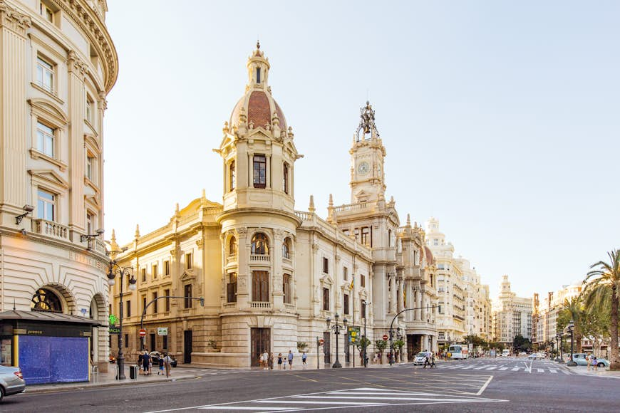 A street lined with large white turreted buildings