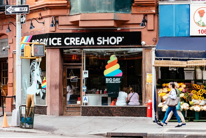 The exterior of an ice cream shop called "Big Gay Ice Cream Shop" with a unicorn licking a cone on the window