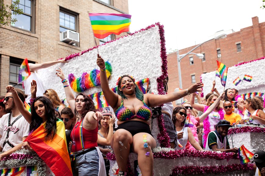 People wave rainbow flags on a float during the New York City Gay Pride Parade