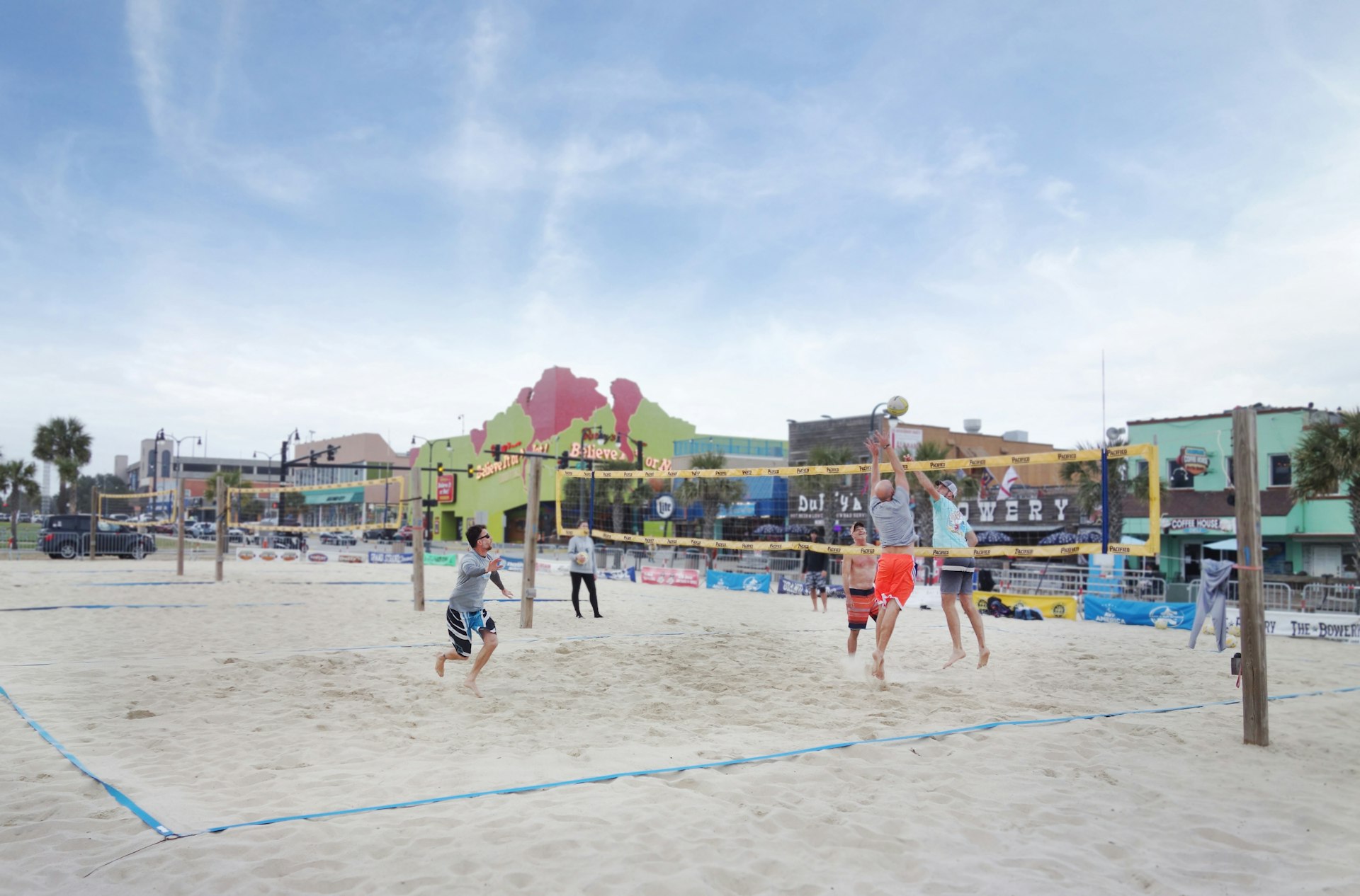 A small group of people play beach volleyball in Myrtle Beach South Carolina