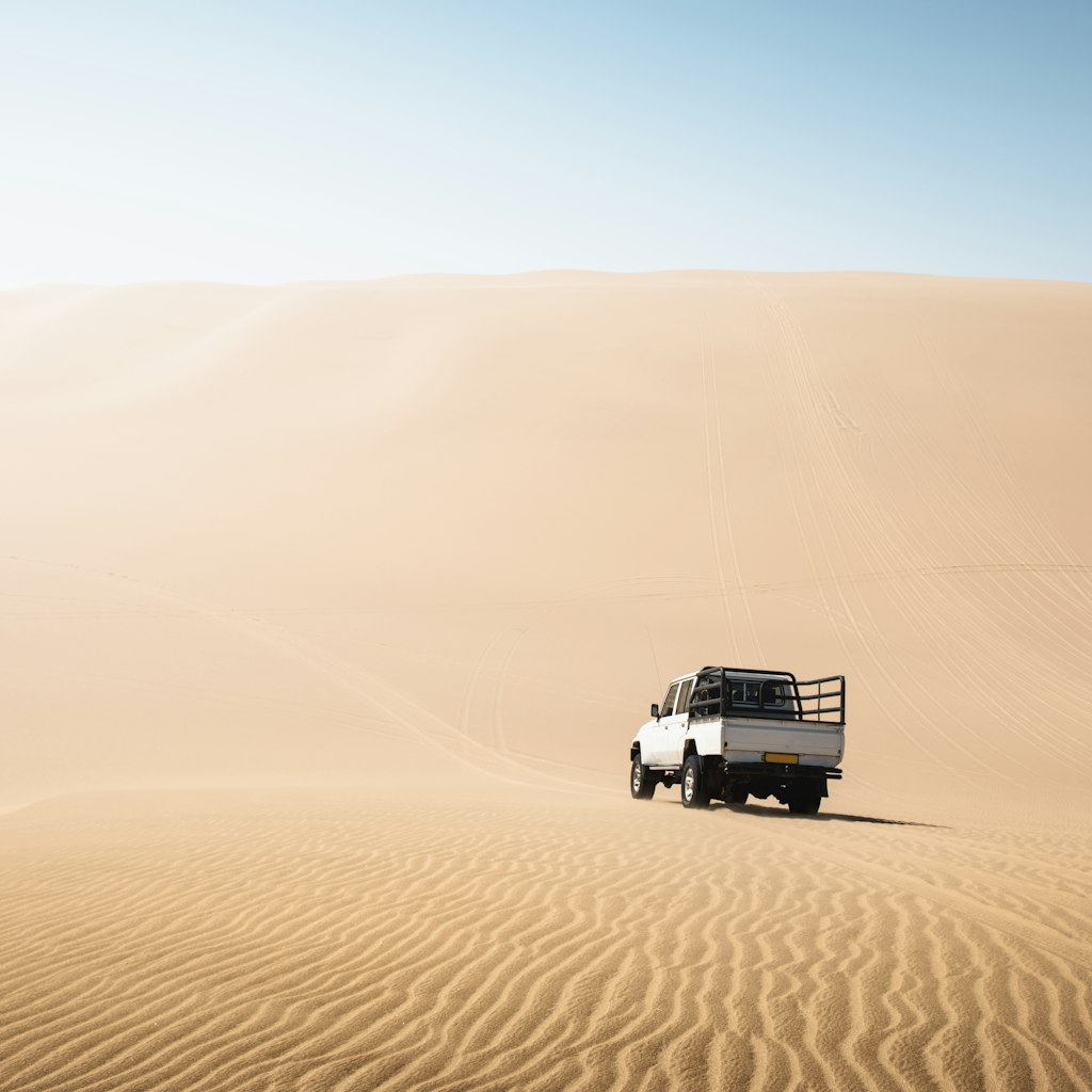 4x4 pick-up driving on sand dunes, Namibia