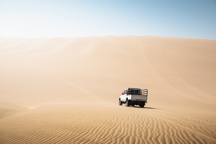 4x4 pick-up driving on sand dunes, Namibia