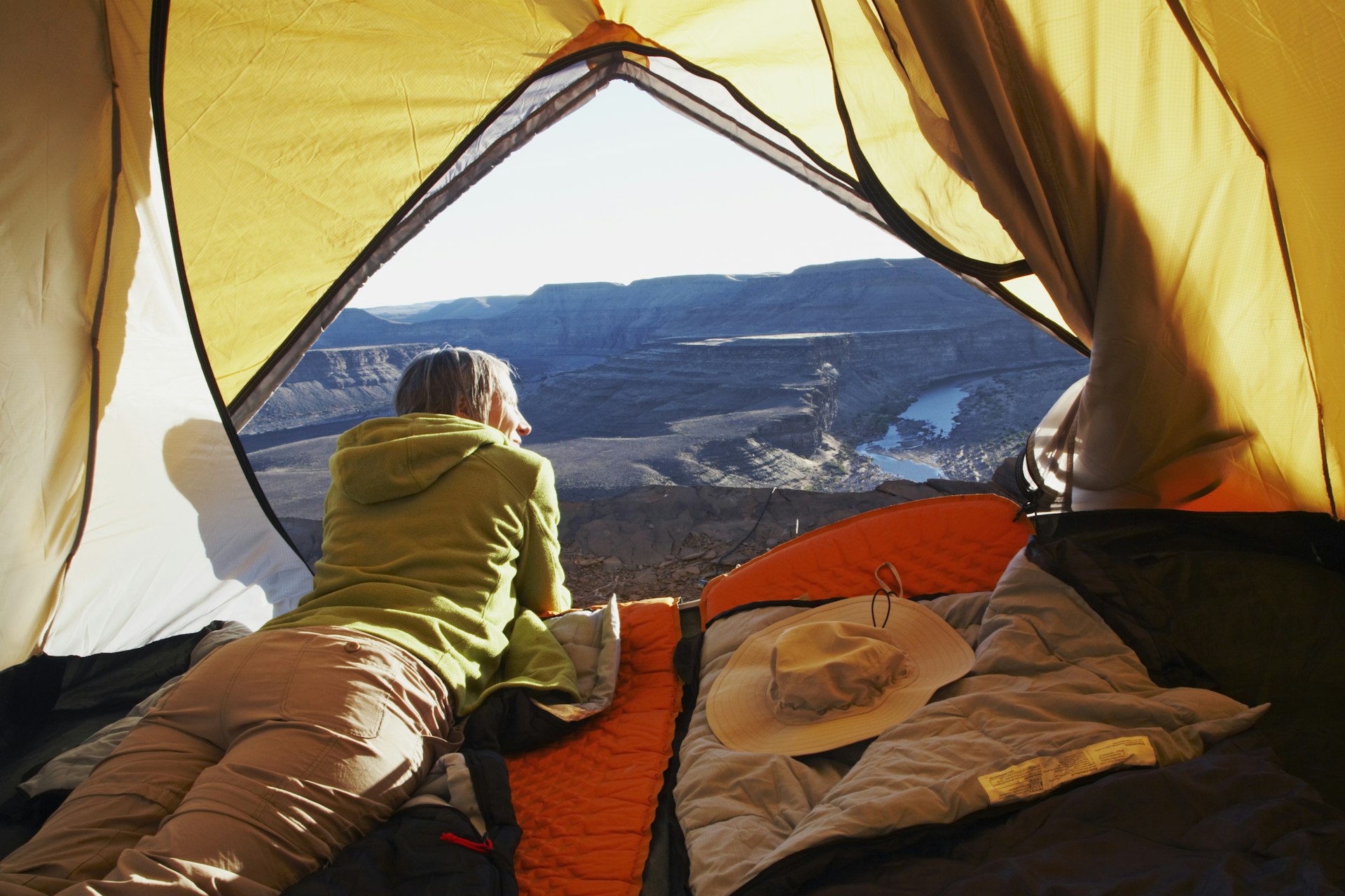 A woman lying in a tent, Horse Shoe Bend, Fish River Canyon, Namibia