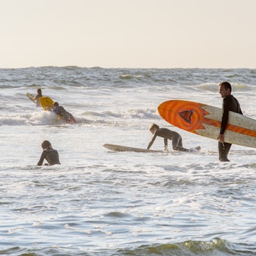 SWAKOPMUND, NAMIBIA - JAN 5, 2016: Unidentified surfer on the Atlantic coast of Swakopmund. It was found in 1892 as the main harbour for German South-West Africa