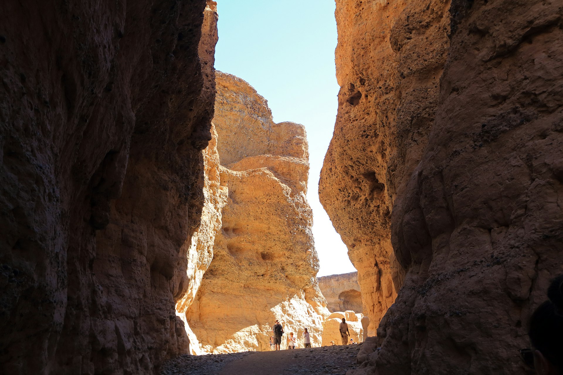 Tourists explore Sesriem Canyon near Sossusvlei. The gorge is shaped by the Tsauchab River in the Namib Desert, Namibia