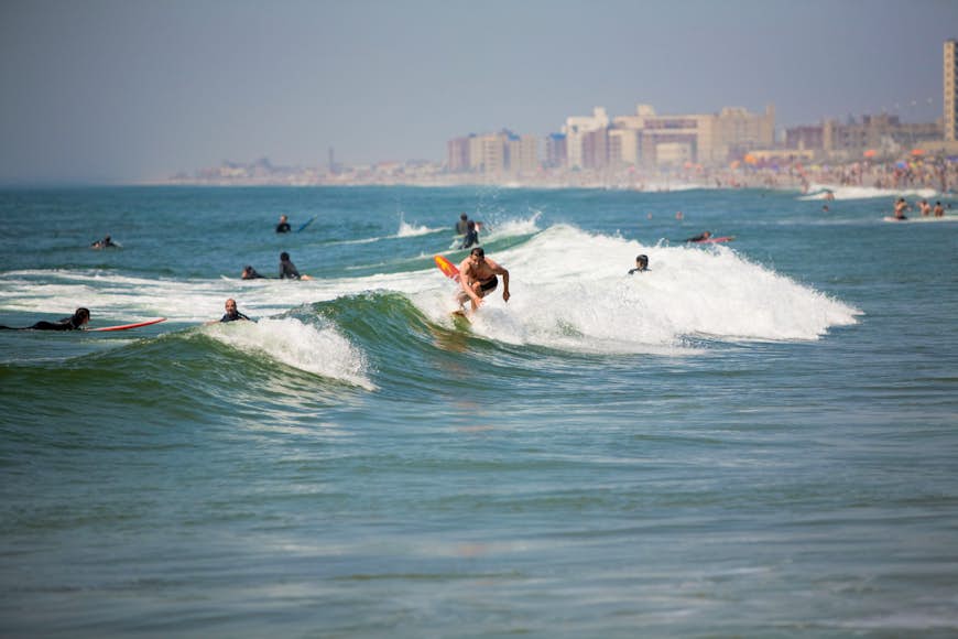Surfing waves of Far Rockaway Beach in June; Far Rockaway Beach Queens, New York