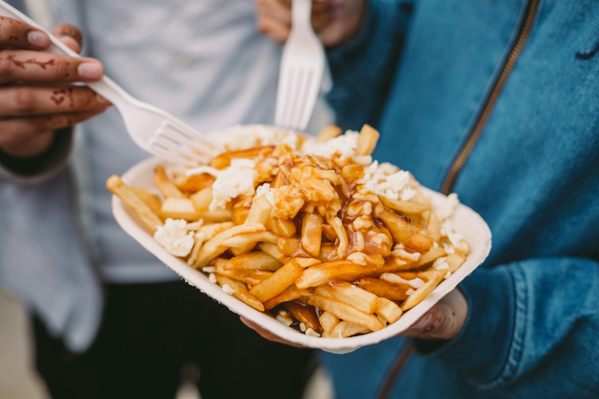 Muslim family eating poutine with forks in Canada
