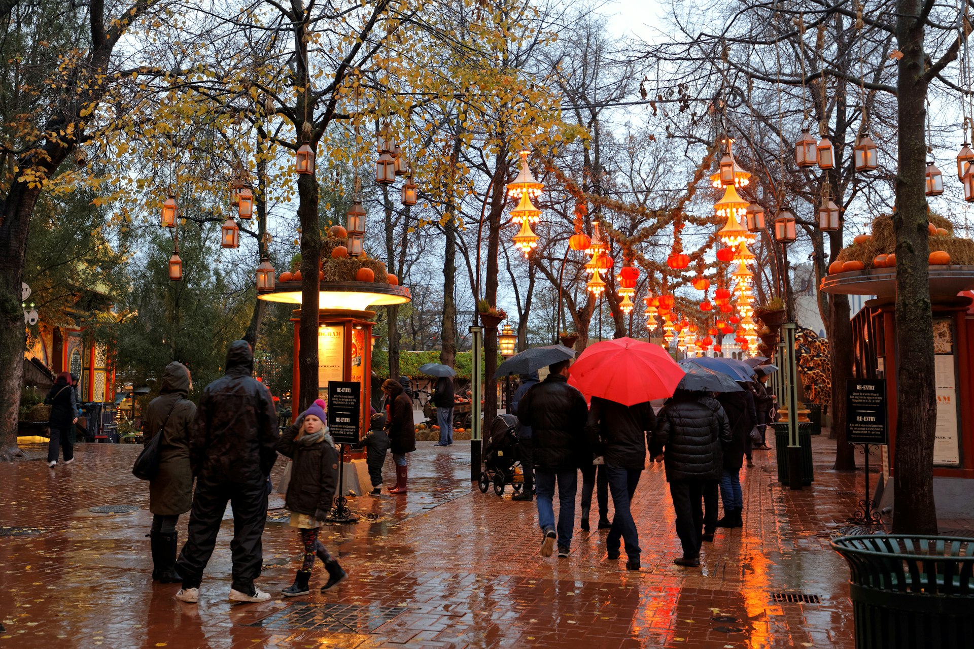 People on a rainy day walk through Tivoli Gardens, Copenhagen