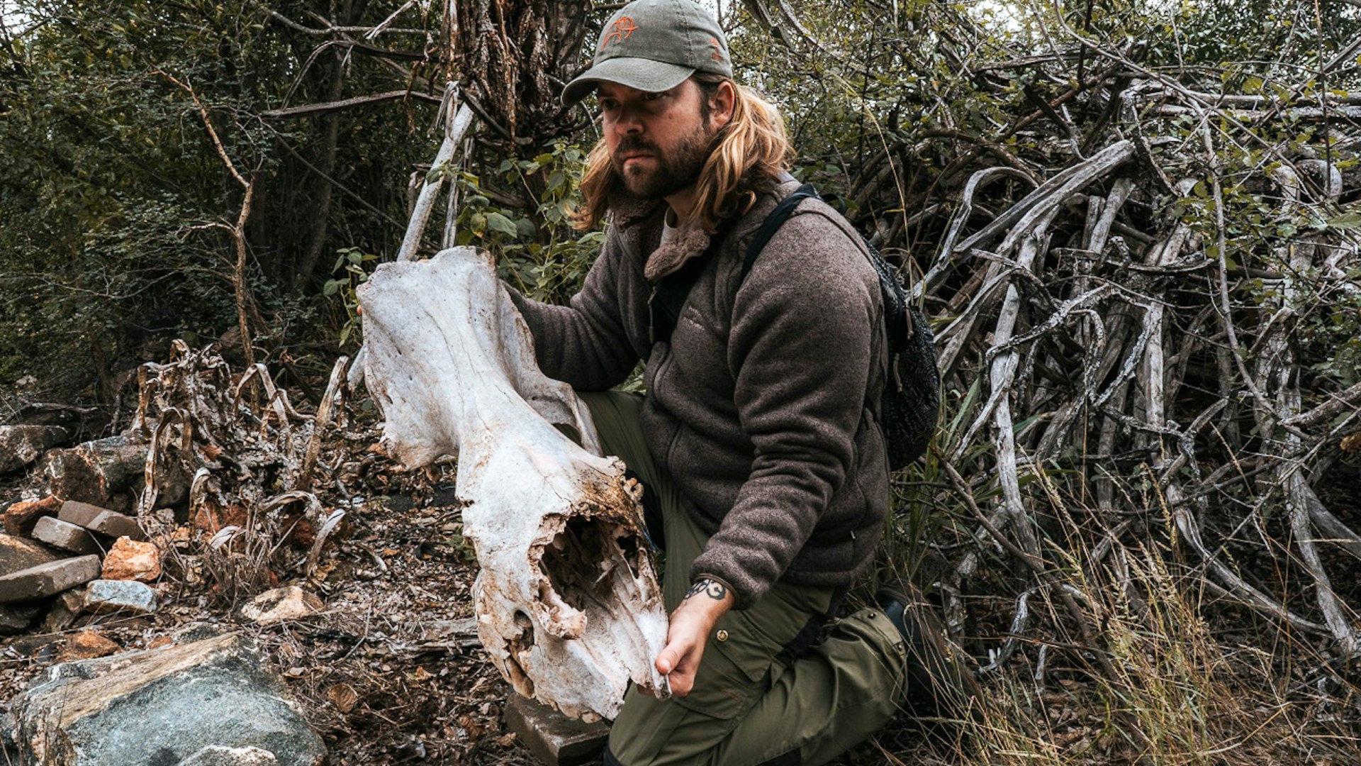 Travel writer Joe Sills holds a rhino skull. 