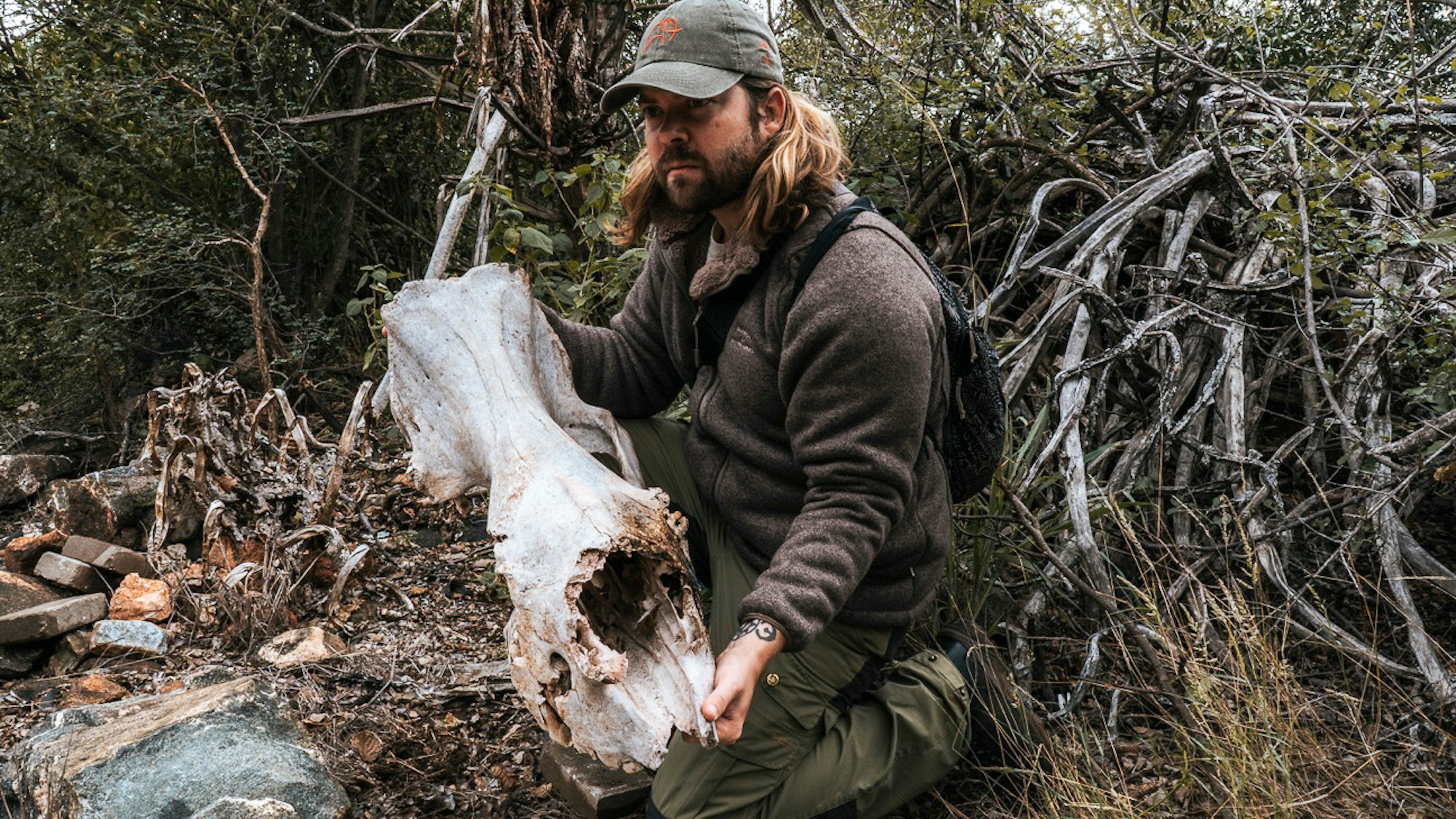 Travel writer Joe Sills holds a rhino skull.