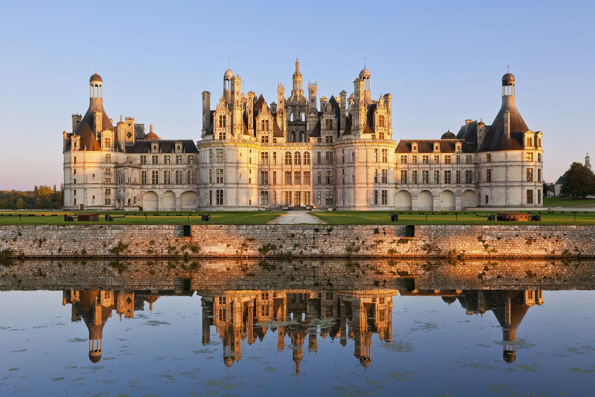 The ornate exterior of the Château de Chambord with its reflection in the lake at the front of the building