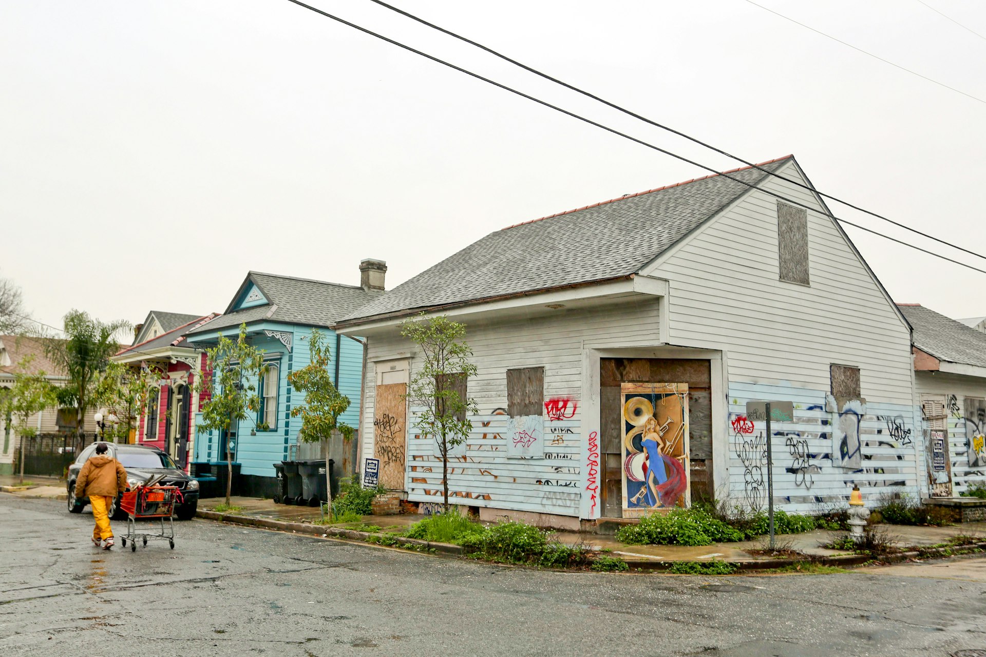 An abandoned, graffiti-covered home stands adjacent to occupied properties in the Bywater neighborhood of New Orleans