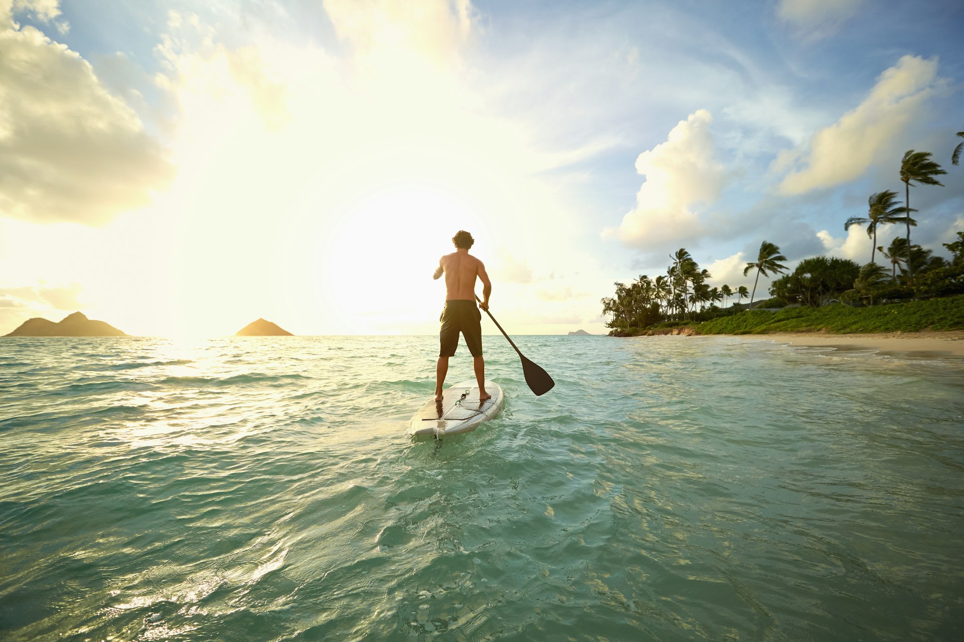 Caucasian man on paddle board in ocean