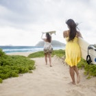 Women headed to the ocean to go surfing in Kailua, HI,