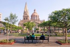 FB6G1K People relaxing in the square (plaza) near the Metropolitana Caatedral (cathedral) in Guadalajara, Mexico