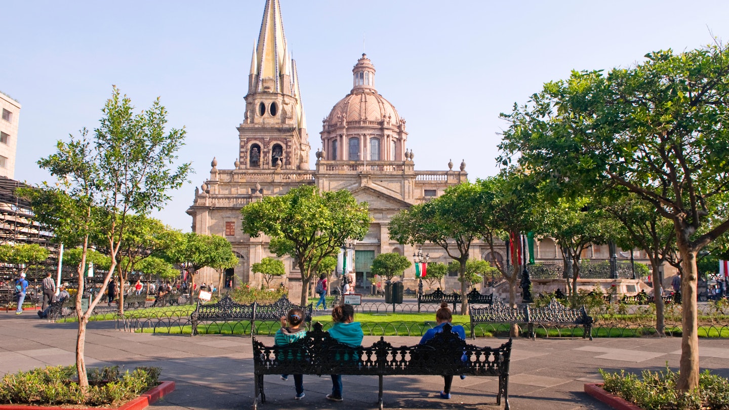 FB6G1K People relaxing in the square (plaza) near the Metropolitana Caatedral (cathedral) in Guadalajara, Mexico