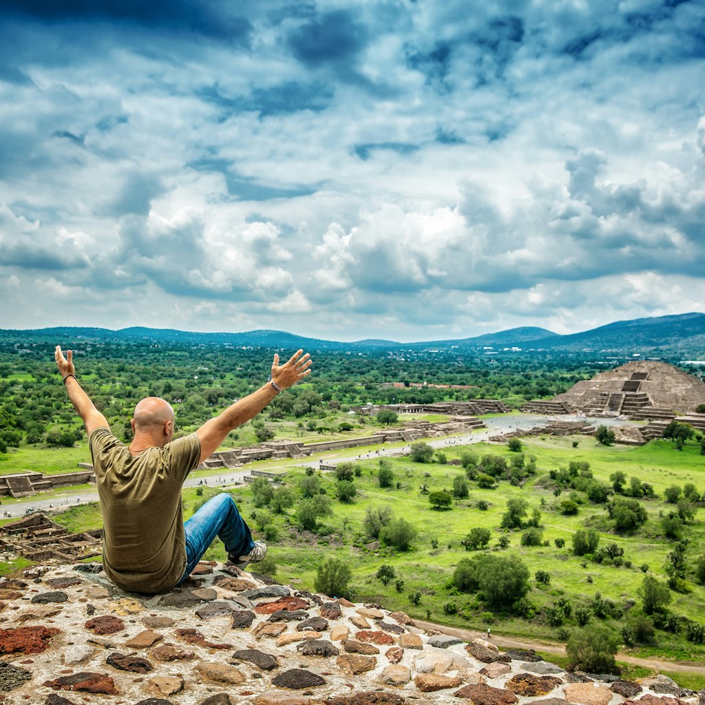 Pyramids of the Sun and the Moon on the Avenue of the Dead, Teotihuacan ancient city, old ruins of Aztec civilization, happy man enjoying traveling, Mexico, North America