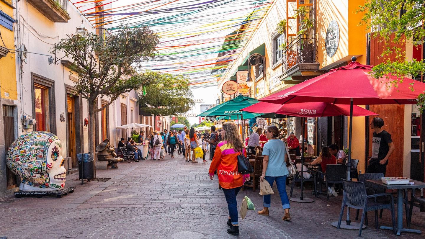 San Pedro Tlaquepaque, Jalisco, Mexico - November 23, 2019: Locals and Tourists exploring the restaurants and shops on Independencia Street