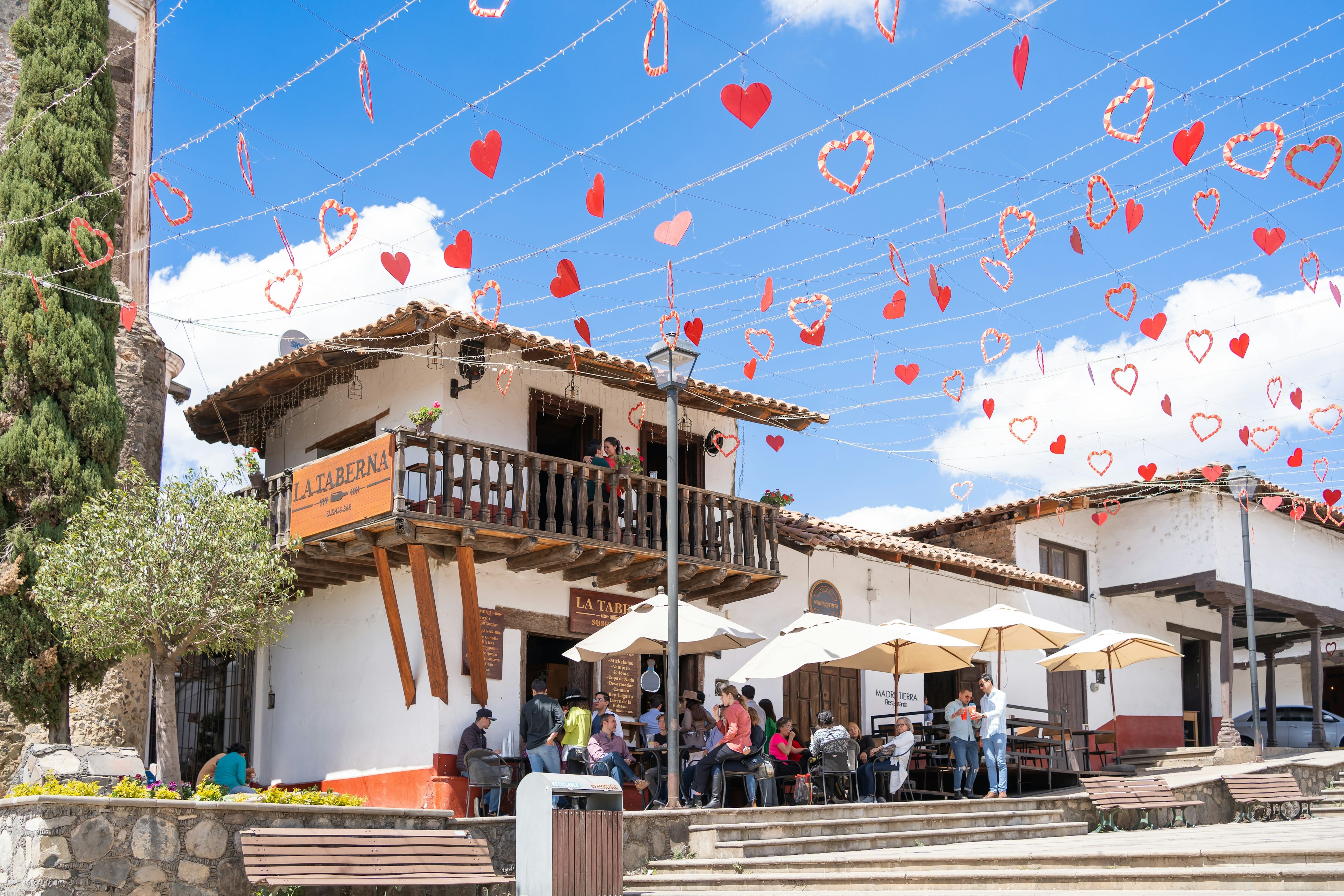 People are enjoying a moment at a bar in the center of the magical town of Tapalpa