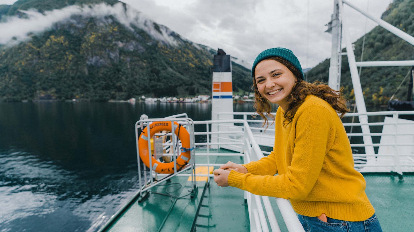 Young Caucasian woman traveling by ferry in Norway