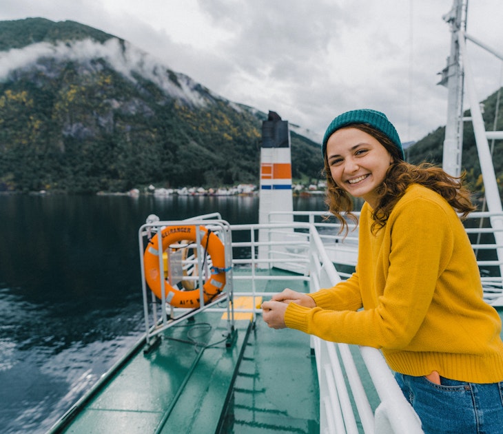 Young Caucasian woman traveling by ferry in Norway